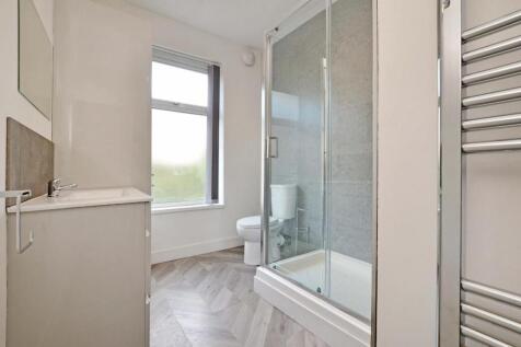 Bright and modern bathroom featuring a spacious...