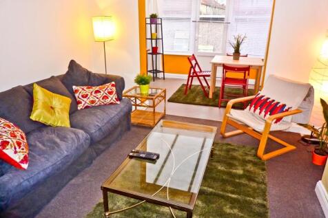 A vibrant living room featuring a cozy couch ad...