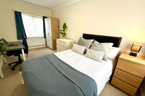 This inviting double bedroom features a cozy be...
