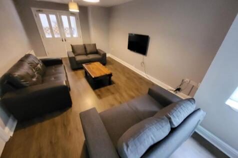 Spacious and inviting living room featuring com...