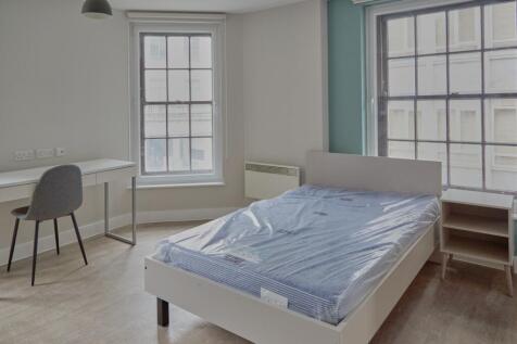 A spacious and bright double bedroom featuring ...
