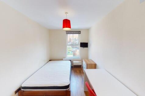 A neat and simple single bedroom featuring a be...