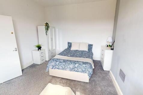 A spacious and inviting double bedroom with amp...