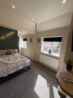 Bright and modern double bedroom featuring a pa...