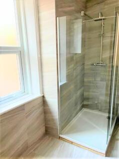 Modern bathroom suite featuring a spacious walk...