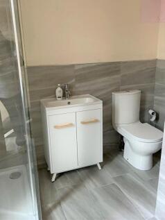 A modern and clean bathroom featuring a white t...