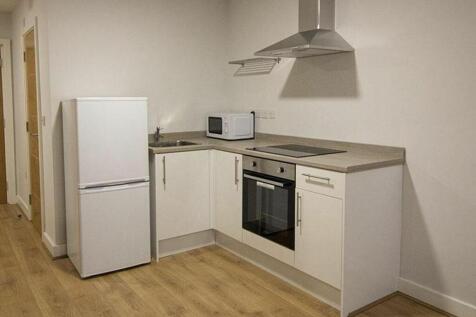 Modern kitchen featuring sleek cabinetry and ap...
