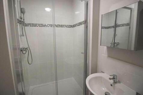 Modern bathroom featuring a spacious shower wit...