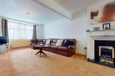 A spacious and inviting living room featuring a...