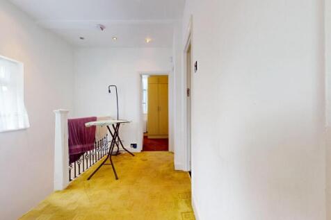 A bright hallway with clean white walls and a l...