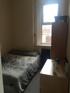 Cozy single bedroom featuring a comfortable bed...