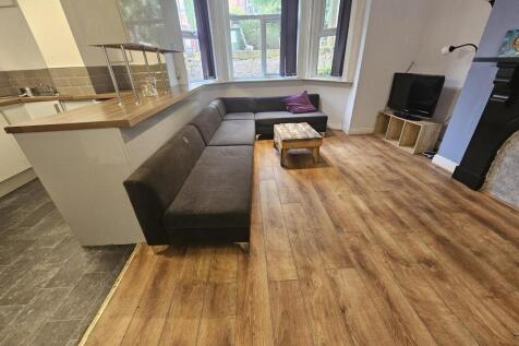 A spacious, well-lit contemporary living room f...