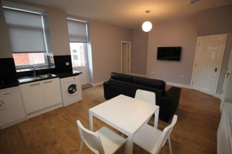 Bright and modern living room featuring a styli...