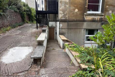 Stone path and steps leading down to a lower-le...