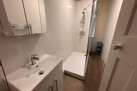 Bright, modern bathroom with a walk-in shower, ...