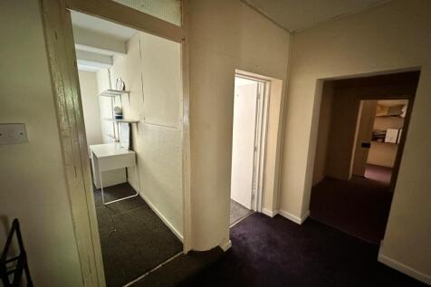 A spacious and tidy hallway providing access to...