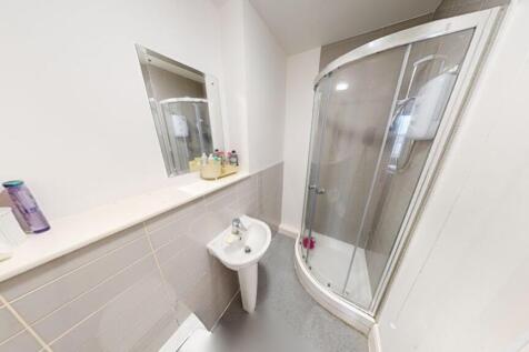 Modern bathroom featuring a stylish shower encl...