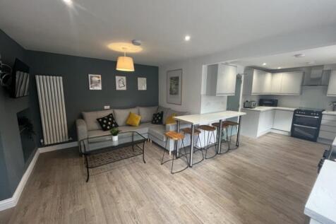 A bright and inviting living room featuring a c...