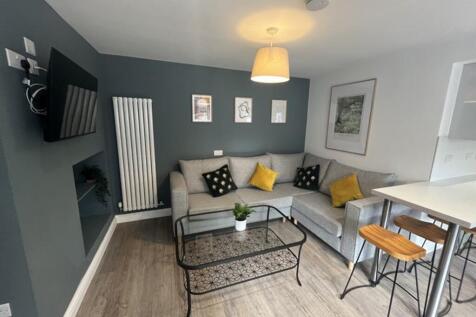 Stylish living room featuring a comfortable gre...