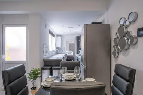 A stylish and modern kitchen featuring sleek ap...