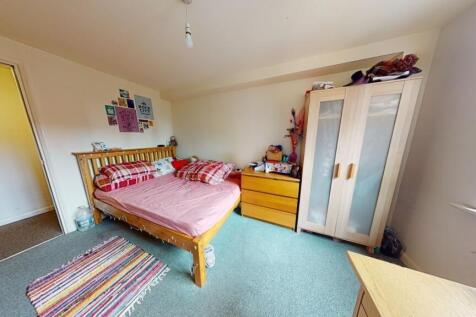 A bright and airy double bedroom featuring a co...