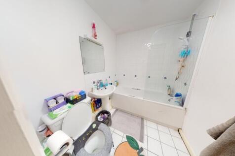 A bright bathroom suite featuring a full bathtu...