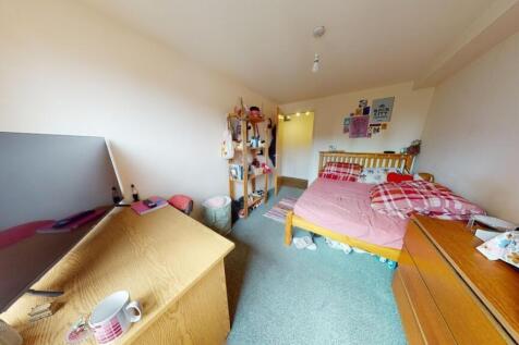 A cozy and functional single bedroom featuring ...
