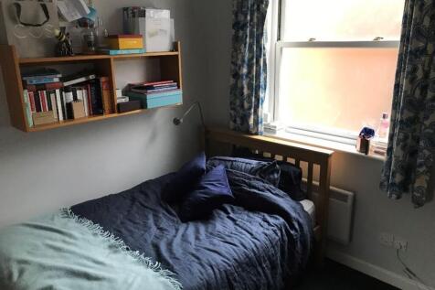 This inviting double bedroom features a cozy be...