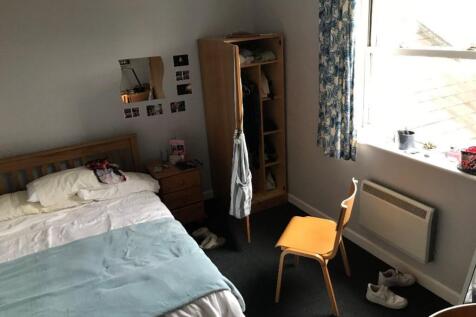 Cozy double bedroom featuring ample natural lig...