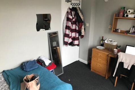 Cozy double bedroom featuring a comfortable bed...