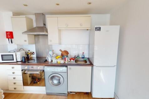 Bright and tidy kitchen featuring modern applia...