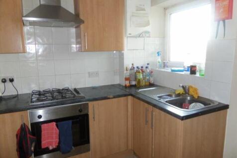 A functional kitchenette with ample storage and...