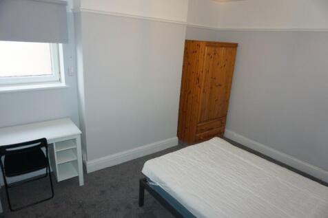 A tidy and inviting double bedroom with a fitte...