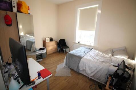 A cozy double bedroom featuring ample natural l...