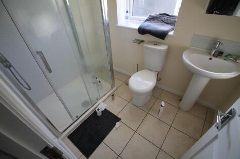 Modern bathroom featuring a spacious shower, cl...