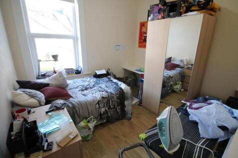 Cozy double bedroom featuring ample natural lig...
