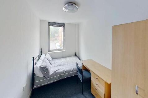 Cozy double bedroom featuring a comfortable bed...