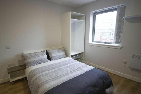 This inviting double bedroom features a comfort...