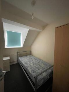 Cozy double bedroom featuring a comfortable bed...