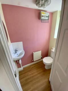 A compact and tidy single toilet featuring a mo...