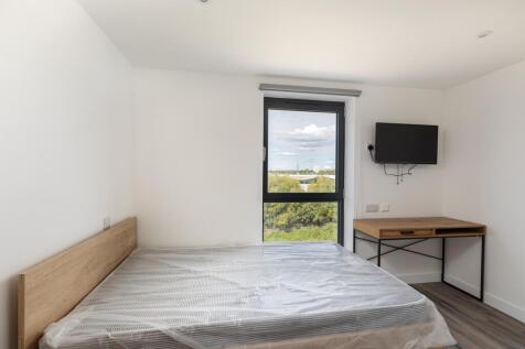 A bright and spacious double bedroom featuring ...