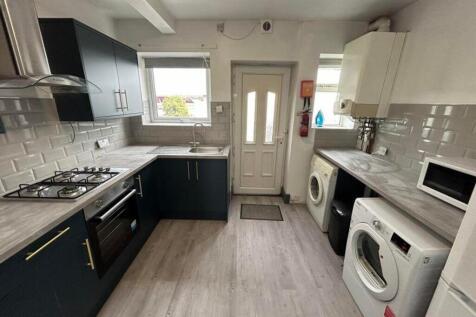 A modern and spacious kitchen featuring ample s...