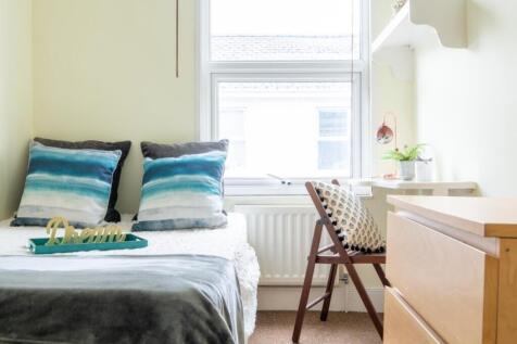 This inviting double bedroom features a cozy at...