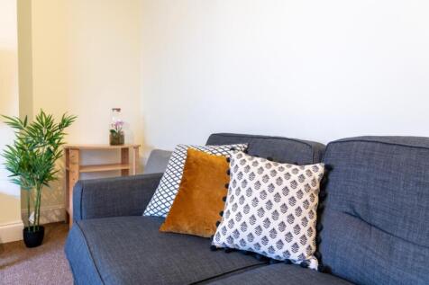A cozy living room featuring a comfortable sofa...