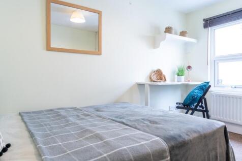 This inviting double bedroom features a cozy la...