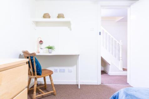 A bright and inviting hallway featuring a simpl...