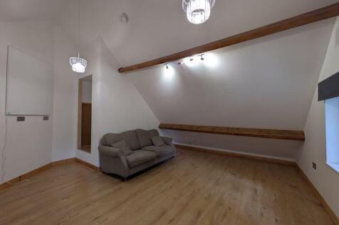 A spacious living room featuring high ceilings ...