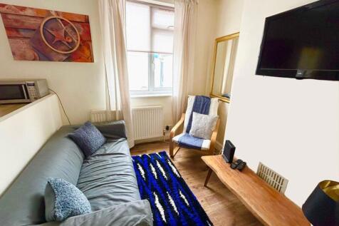 This inviting living room features a cozy sofa,...