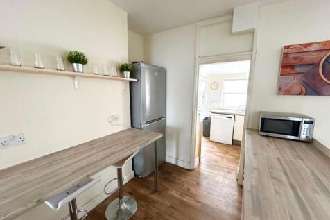 This modern kitchen features sleek countertops,...