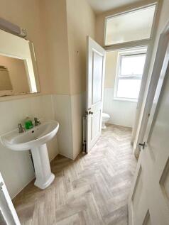 Bright and well-maintained bathroom featuring m...